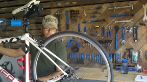 Robert Maye Working on a Bicycle