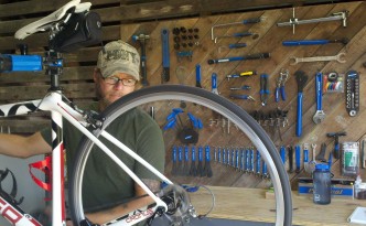 Robert Maye Working on a Bicycle